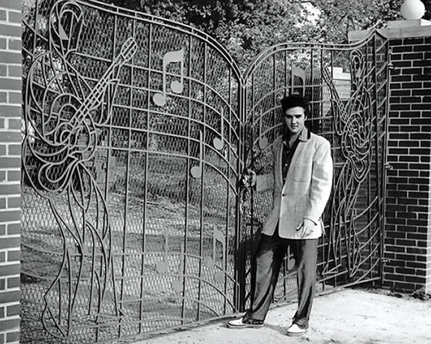 Elvis Presley poses at the new Music Gates for press photo, April 22, 1957. 